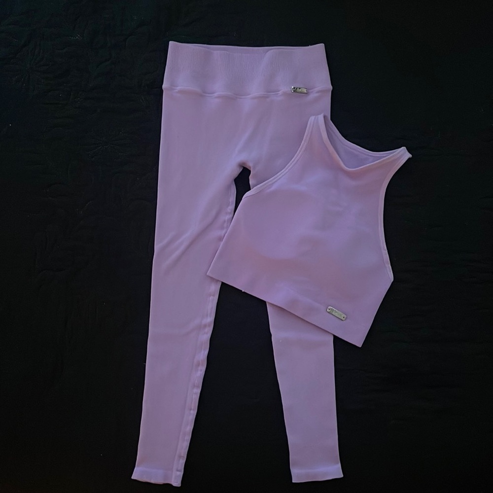 Workout set. Top/medium and bottoms/small size. A few snags noted on photos.